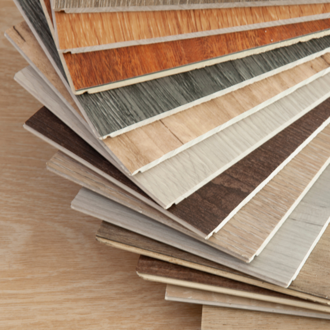 Designer comparing flooring material samples on a showroom table